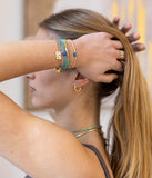 Bracelet Zag Tondela turquoise en acier doré et tissu avec oeil protecteur